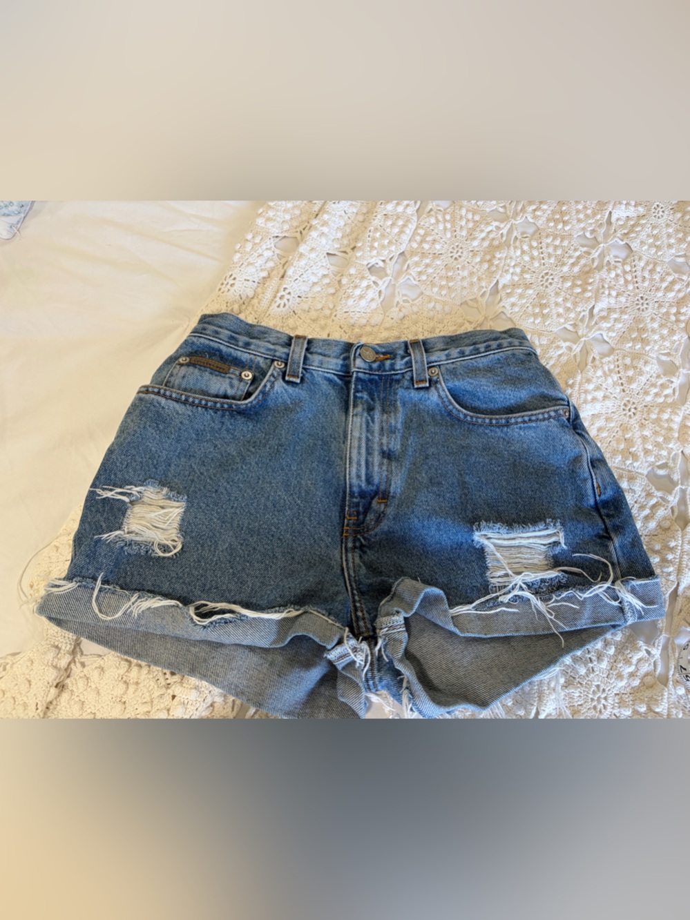 Calvin Klein Vintage High Rise Distressed Denim Cutoff Shorts.